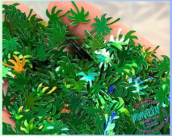 May include: Green iridescent palm tree shaped glitter. The glitter is perfect for adding a tropical touch to crafts, resin projects, and nail art.