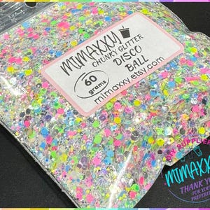 May include: A clear plastic bag filled with colorful chunky glitter, labeled "MIMAXXU CHUNKY GLITTER DISCO BALL 60 grams mimaxxu.etsy.com".