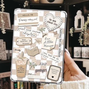 May include: A clear tablet case with a beige and white checkered pattern. The case is decorated with stickers that say "Hello, I'm", "in my smut era", "just one more chapter", "Smut Book Club", "Run Little Mouse", and "Emotional Support Kindle".