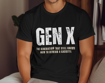 May include: Black t-shirt with white text that reads "GEN X THE GENERATION THAT STILL KNOWS HOW TO REWIND A CASSETTE"