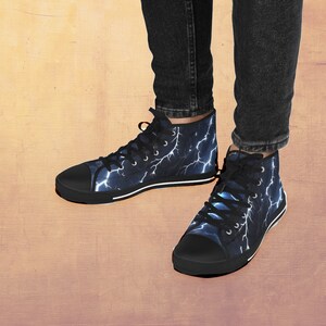 May include: A pair of black high-top canvas shoes with a blue and white lightning bolt pattern.