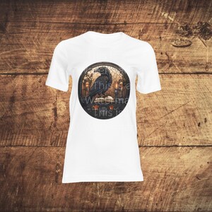 May include: White t-shirt with a circular graphic of a black raven perched on a book with candles and roses. The text "This is a Waste of Time This is"