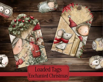 May include: Two decorative paper tags featuring Christmas illustrations of a child and a mouse in a winter setting with holly, red berries, and a red door. The text Loaded Tags Enchanted Christmas is printed in a red rectangular frame.