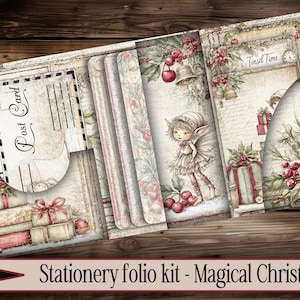 May include: A stationery folio kit with a vintage Christmas theme. The kit features illustrations of fairies, gifts, bells, and berries. The text "Post Card" and "Tinsel Time" are visible. The overall color palette includes beige, red, and green.