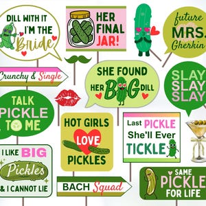 May include: A collection of pickle-themed photo booth props with various phrases and illustrations. The props include speech bubbles with text like "Dill With It, I'm the Bride" and "She Found Her Big Dill." Other props feature pickles, hearts, and martini glasses.