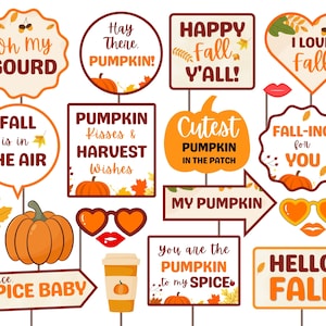May include: A set of 12 fall-themed photo booth props with various sayings, including "Oh my gourd", "Happy Fall Y'all", "Fall is in the air", "Pumpkin Kisses & Harvest Wishes", "Cutest Pumpkin in the Patch", "My Pumpkin", "You are the Pumpkin to my Spice", "Spice Spice Baby", "Fall-ing for You", "I Love Fall", "Hello Fall", and "Hay There Pumpkin!" The props are printed on white cardstock with brown, orange, and yellow accents.