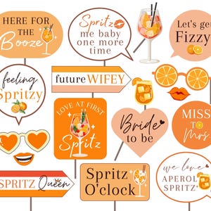 May include: A set of 12 orange and white printable photo booth props with text such as "Here for the Booze", "Spritz me baby one more time", "future wifey", "Bride to be", "Miss to Mrs", "Spritz Queen", "Spritz O'clock", "We love Aperol Spritz", and "Let's get Fizzy!"