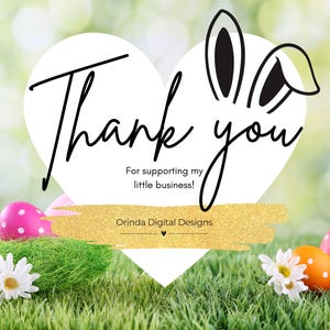 May include: Thank you for supporting my little business! Orinda Digital Designs. A white heart with bunny ears on a green grassy background with colourful Easter eggs.