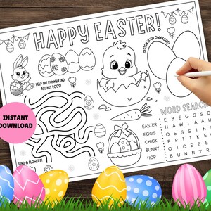 May include: A black and white printable coloring page with an Easter theme. The page features a chick in an eggshell, a bunny rabbit in a maze, a basket of eggs, and a word search puzzle. The text "Happy Easter!" is at the top of the page.