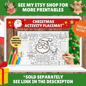 May include: A digital Christmas activity placemat displayed on a laptop screen. The black and white design includes a Santa Claus illustration, word search, and word scramble. The screen also displays the text "MERRY CHRISTMAS". A gift box and pencils are in the foreground.