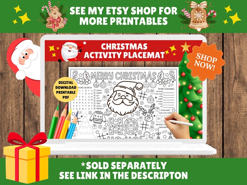 May include: A digital Christmas activity placemat displayed on a laptop screen. The black and white design includes a Santa Claus illustration, word search, and word scramble. The screen also displays the text "MERRY CHRISTMAS". A gift box and pencils are in the foreground.