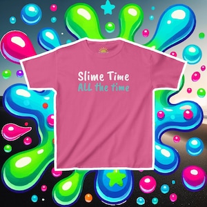 May include: Pink t-shirt with the text "Slime Time All the Time" in blue and green lettering. The shirt is surrounded by colorful slime splatters.