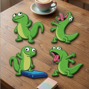 May include: Four embroidered patches featuring green lizards with light green bellies in various poses. One lizard stands, one has its mouth open with a pink tongue, one stands on a blue rectangular object, and one has a wide-eyed expression.