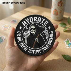 May include: A circular black embroidered patch featuring a white graphic of a skeleton wearing sunglasses, holding a water bottle and a scythe. The text reads HYDRATE OR DIE TRYIN' OUTLIVE YOUR ENEMIES in white capital letters around the border.