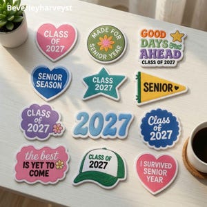 May include: A collection of twelve embroidered patches featuring various shapes and colors with text including Class of 2027, Senior Season, Good Days Ahead, The Best Is Yet To Come, and I Survived Senior Year, arranged on a flat surface.