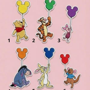 May include: Six embroidered patches featuring cartoon characters holding Mickey Mouse-shaped balloons. Characters include Winnie the Pooh with a yellow balloon, Tigger with green, Piglet with purple, Eeyore with orange, Rabbit with blue, and Roo with red.