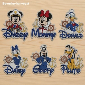 May include: Six embroidered patches featuring Disney characters in nautical attire, including Mickey Mouse labeled Daddy, Minnie Mouse labeled Mommy, Donald Duck, Daisy Duck, Goofy, and Pluto, each with a ship wheel and anchor icon.