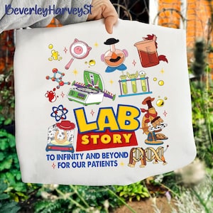 May include: White tote bag featuring a colorful design with the words "LAB STORY" in yellow and red. The design includes cartoon illustrations of lab equipment and characters, with the text "TO INFINITY AND BEYOND FOR OUR PATIENTS".