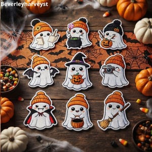 May include: Nine embroidered ghost patches featuring various Halloween themes, including ghosts wearing orange or black beanies, holding books, pumpkins, cameras, or brooms, and wearing vampire capes or witch hats, arranged on a wooden surface.