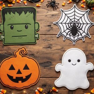 May include: Four felt Halloween decorations including a green Frankenstein monster, a black and white spider web with a spider, an orange jack-o'-lantern pumpkin, and a white ghost, all featuring stitched outlines and simple facial expressions.