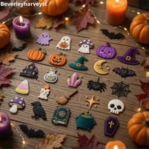 May include: A collection of embroidered Halloween-themed patches featuring ghosts, pumpkins, a witch hat, a crescent moon, a bat, a spider, a web, a skull, a coffin, a potion bottle, a crystal, a broom, a book, a raven, and mushrooms.