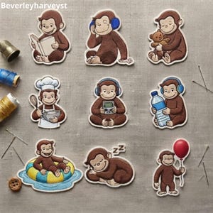 May include: A collection of nine embroidered patches featuring a brown monkey in various activities, including reading a book, wearing blue headphones, holding a teddy bear, cooking, playing a handheld game, holding a water bottle, swimming, sleeping, and holding a red balloon.