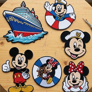 May include: Embroidered patches featuring Mickey Mouse and Minnie Mouse in various designs. Includes a cruise ship, Mickey in a life preserver, and Minnie Mouse at the helm. The patches are colorful and detailed, with the text "BEVERLEYHARVEYST" at the top.