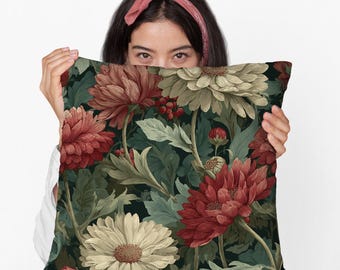 May include: Square throw pillow with a floral pattern featuring large red and cream-colored flowers, green leaves, and berries against a dark background. The pillow has a vintage, botanical design.