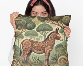 May include: A decorative throw pillow with a brown and green patterned design featuring a stylized donkey in a forest setting.