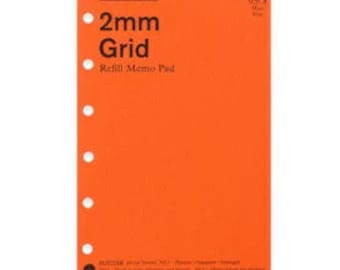 May include: A bright orange rectangular refill memo pad with a 2mm grid pattern. The cover features the text PLOTTER, 004, 2mm Grid, and Refill Memo Pad in black. The left side has six circular punched holes for binding in a planner system.