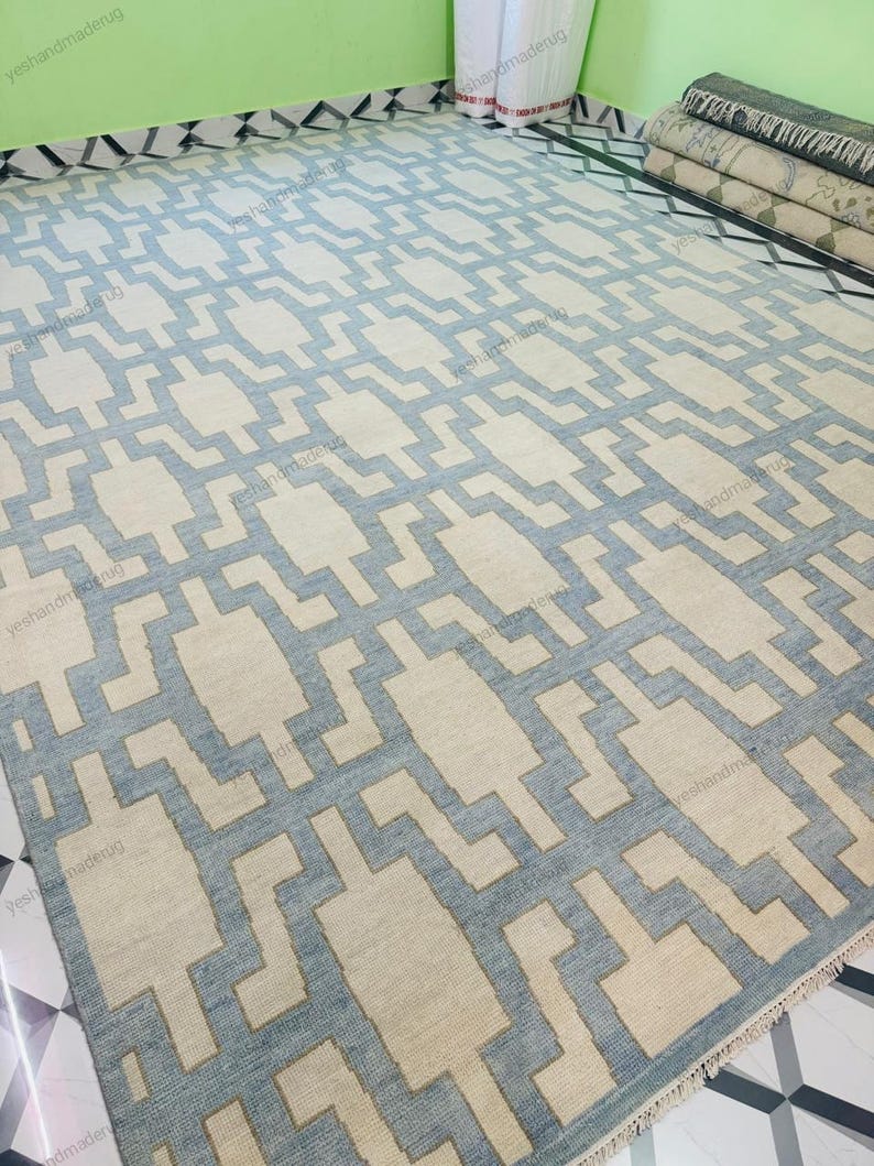 Detail shot of the rug’s surface texture showing high-quality wool fibers and tight handwoven construction. This geometric flatweave rug combines durability with a soft feel, making it suitable for high-traffic areas. The beige and blue color scheme enhances modern and minimalist interiors. Perfect as an area rug for living rooms or bedrooms, this handmade wool rug reflects fine craftsmanship and stylish home décor aesthetics.