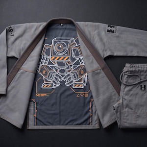May include: A grey martial arts gi set featuring a jacket and pants. The jacket interior displays a large graphic of a robot with orange accents and the text XR-7 and XG-006. The sleeve and pants feature a black patch with the text XELENT.