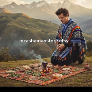 May include: A person kneeling on a colorful woven blanket, wearing a blue, white, and orange patterned poncho. The blanket is adorned with various items, including bowls and flowers. The background features rolling green hills and mountains. The text "incashamanstore.etsy" is visible.