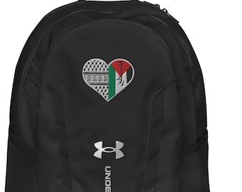 May include: Black Under Armour backpack with a heart-shaped emblem featuring a flag design. The backpack has the Under Armour logo and text in white. It has a top handle and side pockets.