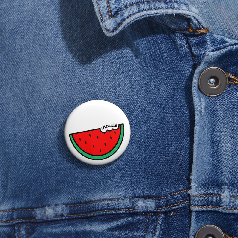 On a jean jacket, a small Palestine Watermelon Button Pin Badge for Those Who Stand with Palestine, Gaza and the Holy Land, No More Oppression. 786 Peace. Salam.