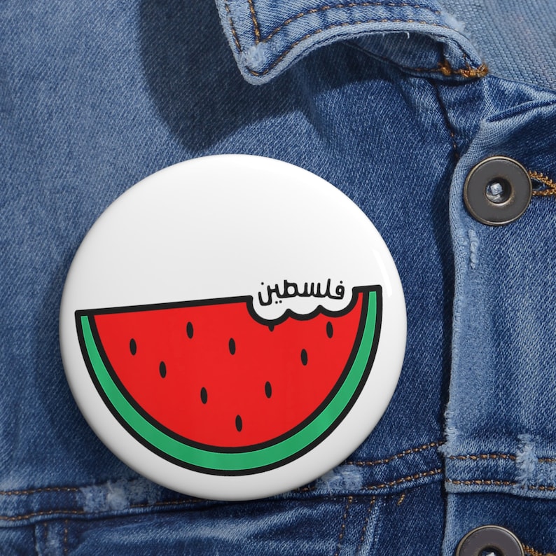 On a jean jacket, a large Palestine Watermelon Button Pin Badge for Those Who Stand with Palestine, Gaza and the Holy Land, No More Oppression. 786 Peace. Salam.