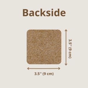 Backside of the coaster showing the material of the back which is cork and the size of each side of the square which is 3.5" (9 cm)