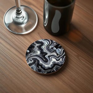 Close-up of a coaster featuring a bold black and white agate-inspired pattern with fluid, high-contrast waves creating a dramatic effect.