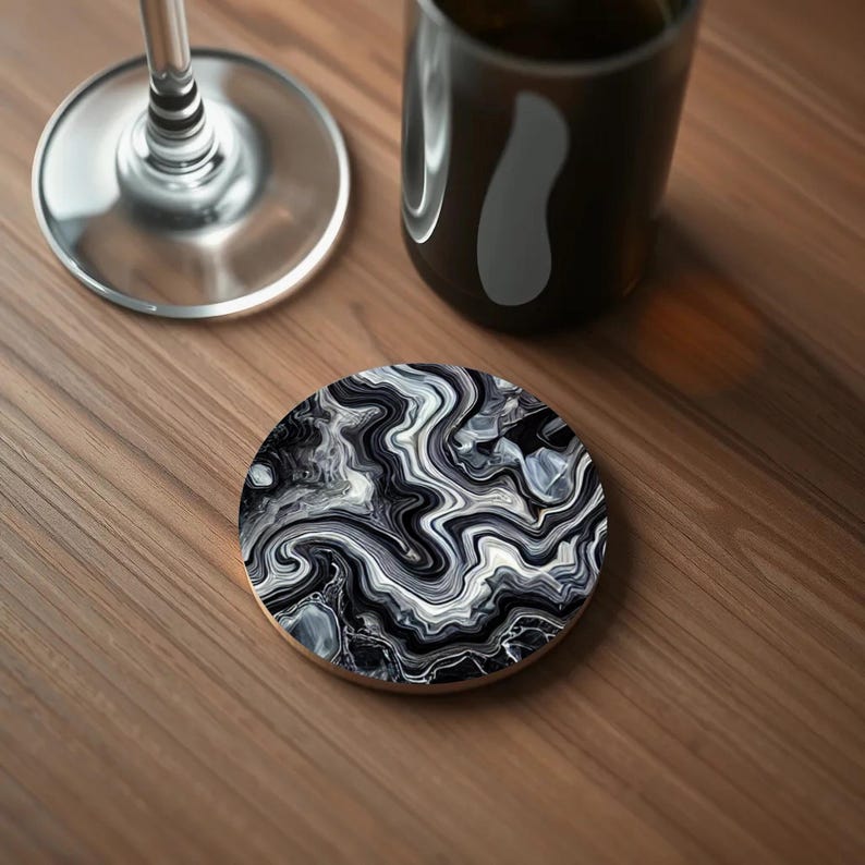 Close-up of a coaster featuring a bold black and white agate-inspired pattern with fluid, high-contrast waves creating a dramatic effect.