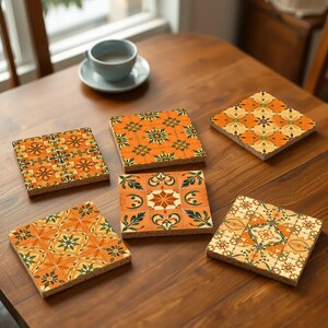 May include: Set of six orange and green patterned coasters with a geometric design. The coasters are made of cork and are square shaped.