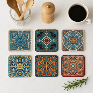 May include: Six square coasters with intricate, colorful, and ornate designs. The coasters feature shades of blue, gold, red, and cream, with floral and geometric patterns. Some coasters have the word "YEREVAN" printed on them.