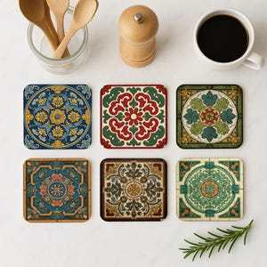 May include: Six square coasters with intricate, colorful designs. The coasters feature floral and geometric patterns in shades of blue, green, red, and gold. A cup of coffee, wooden spoons, and a pepper grinder are also visible.