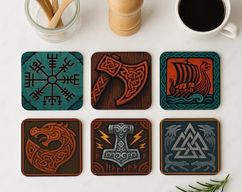 May include: Set of six coasters featuring various Viking-themed designs. The coasters are made of cork and feature a variety of designs, including a compass, an axe, a ship, a hammer, and a knot. The coasters are all in a dark brown color with red, blue, and white accents.