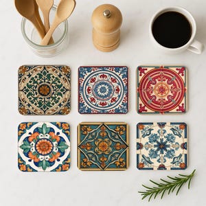 May include: Set of six colourful ceramic coasters with intricate geometric patterns. The coasters feature a variety of colours, including blue, red, green, and yellow. The coasters are perfect for protecting your furniture from scratches and spills.