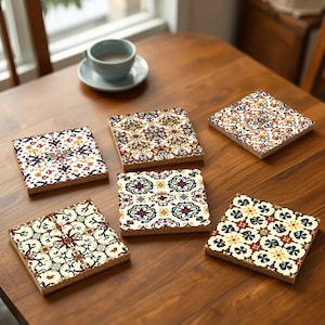 May include: Six colorful coasters with intricate geometric patterns in shades of blue, red, yellow, and white. The coasters are made of a durable material and are perfect for protecting surfaces from heat and spills.