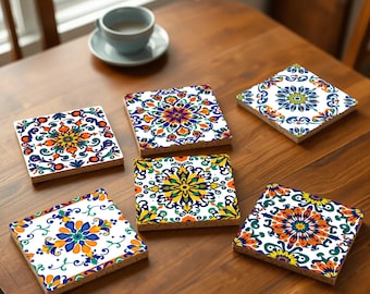 May include: Six colorful ceramic coasters with intricate floral patterns in shades of blue, yellow, orange, and green. The coasters are square and have a white background.