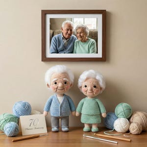 May include: A framed photograph of an elderly couple hangs above two crocheted dolls resembling the couple. The dolls are dressed in blue and green outfits, with white hair. A card reads "70 Platinum Anniversary."