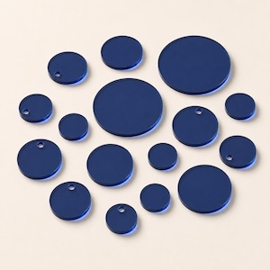 May include: A collection of fifteen circular navy blue acrylic discs of varying sizes arranged in a cluster. Several of the discs feature a small, circular hole near the edge, while others are solid circles without any holes or markings.