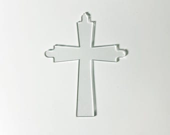May include: A clear acrylic cross with a simple design. The cross is a religious symbol and can be used for decoration or as a craft supply.