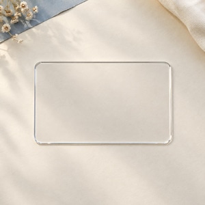 May include: A rectangular, clear acrylic sign blank with smooth, rounded corners. The transparent, flat piece features a polished edge finish and a simple, clean design, providing a versatile surface for custom lettering or decorative projects.